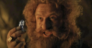 Owain Arthur as Durin IV, holding a piece of mithril