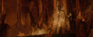 An armoured Sauron in the volcanic chamber of Sammath Naur, with the One Ring on his finger, as depicted in Peter Jackson's film adaptation of The Fellowship of the Ring