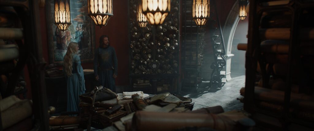 Galadriel and Elendil stand in front of a tapestry of Elrond and Elros in the Hall of Lore