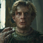 Celebrimbor looking disheveled and shocked, while his hand is covered in a black liquid