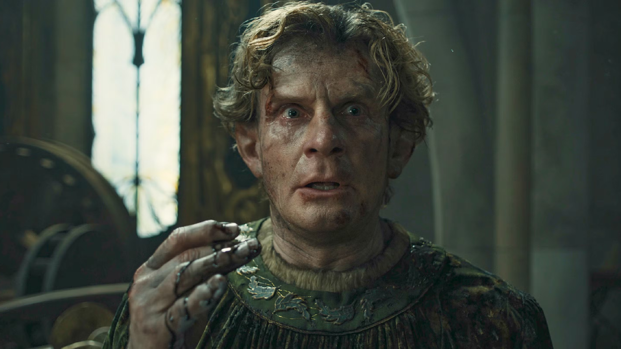 Celebrimbor looking disheveled and shocked, while his hand is covered in a black liquid