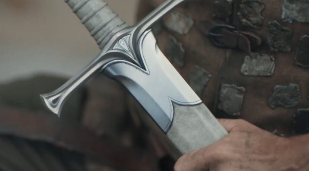 An extreme close up on Elendil's hand holding his new sword Narsil, in season 3 costume
