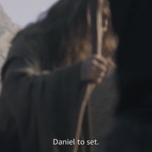 A blurry image of Daniel Weyman in costume as future-Gandalf, holding a staff, with subtitle "Daniel to set" spoken by an off-camera person