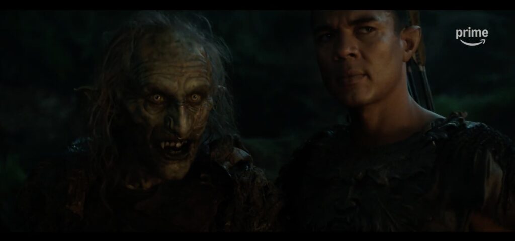 Front-on shot of Arondir and the orc Marnûkh in a night scene