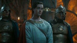 Leon Wadham as Kemen in season 2 of Rings of Power, looking smug with soldiers next to him