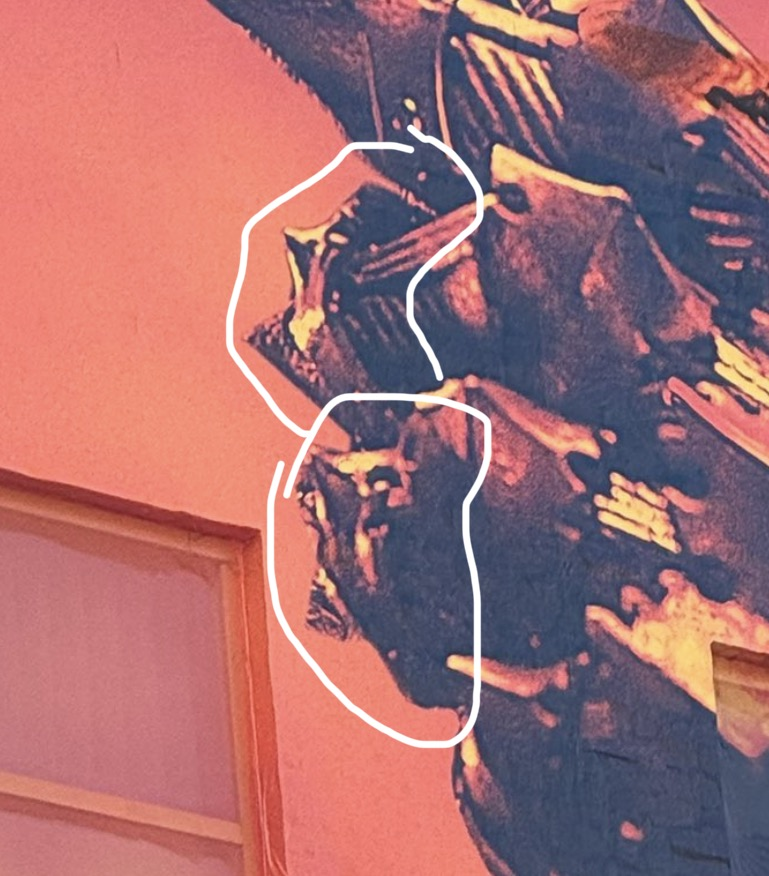 Zoomed-in picture of Sauron's gauntlet from the full building wrap. He appears to have rings on his third and fourth fingers, and they have been roughly circled in white by the post author