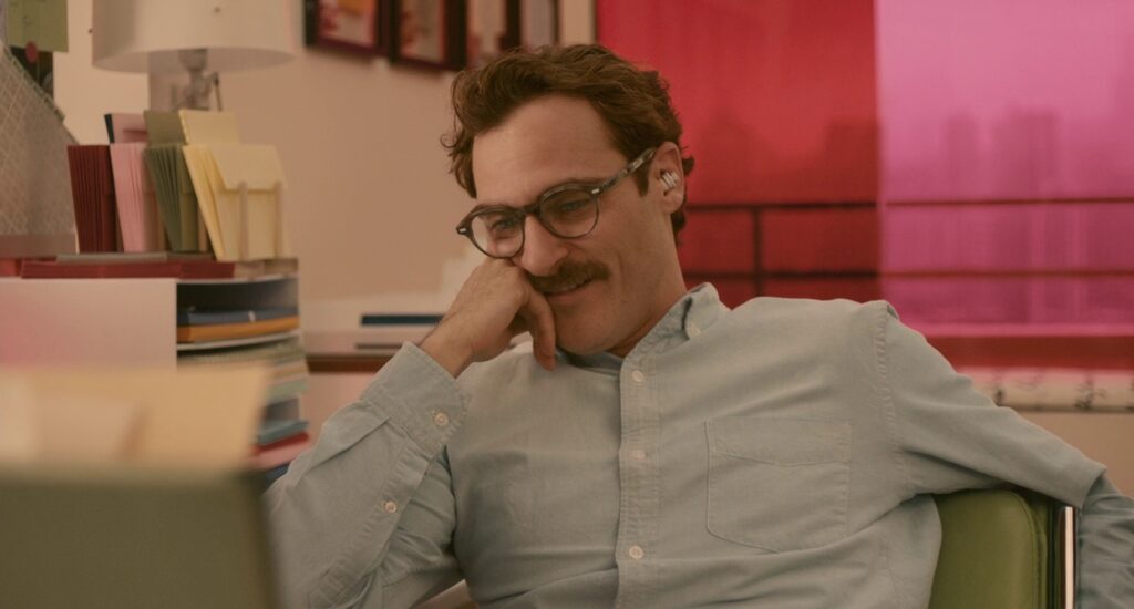 Man sitting at an office desk resting his elbow on desk