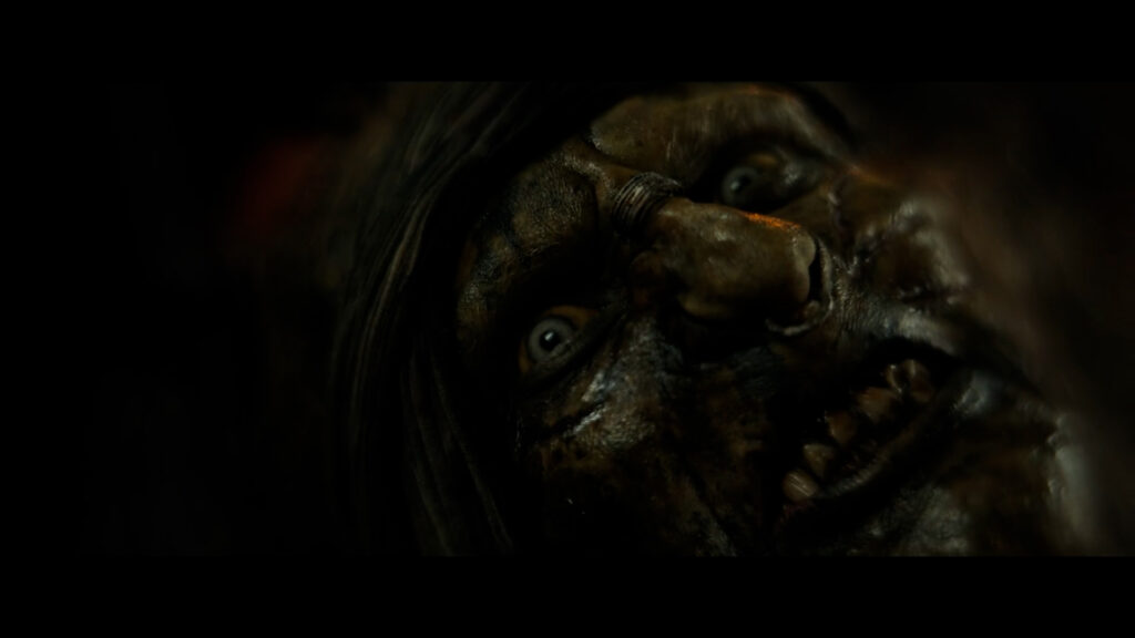 Extreme close-up in a dark shot on Marnûkh's face in a Dutch angle. He looks slightly panicked