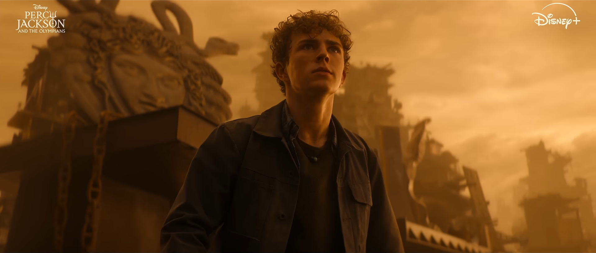Percy Jackson looking up with apprehension at something out of shot. Credit: Disney