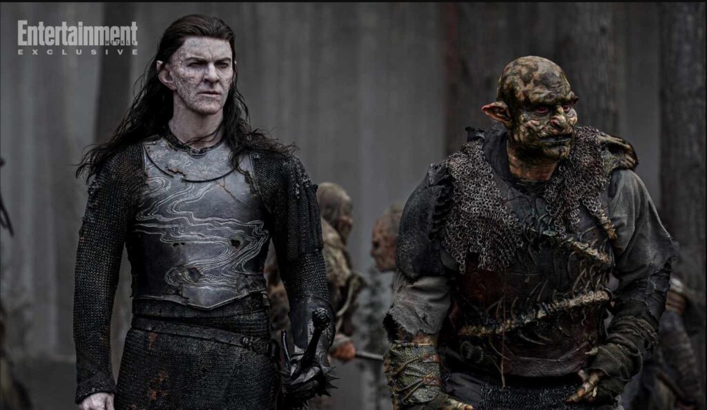 The Moriondo Adar with an orc in a forest, from season 2. Adar's breastplate shows a winding river motif inscribed in the metal