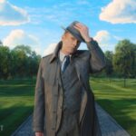 Centered shot of Vision in the garden of his mind palace, just about to take off his brimmed hat